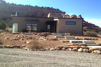 Design ideas for a mid-sized southwestern drought-tolerant and full sun hillside gravel landscaping in Denver for spring.