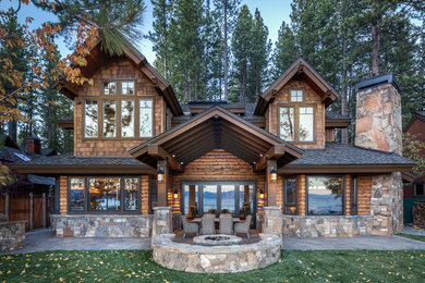 Example of a mid-sized mountain style brown two-story mixed siding gable roof design in Sacramento