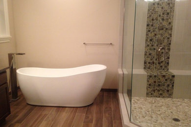 Large elegant master brown tile and ceramic tile ceramic tile bathroom photo in Portland with an undermount sink, shaker cabinets, dark wood cabinets, granite countertops, a two-piece toilet and beige walls