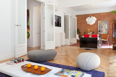 Inspiration for a large contemporary open concept and formal light wood floor living room remodel in Madrid with white walls, no fireplace and no tv