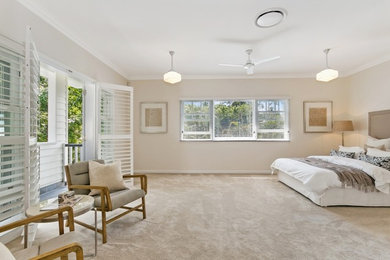 Photo of an expansive traditional master bedroom in Brisbane with beige walls, carpet and beige floor.