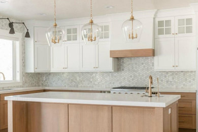 Eat-in kitchen - large contemporary l-shaped light wood floor and brown floor eat-in kitchen idea in Houston with an undermount sink, shaker cabinets, white cabinets, quartzite countertops, white backsplash, mosaic tile backsplash, white appliances, an island and white countertops