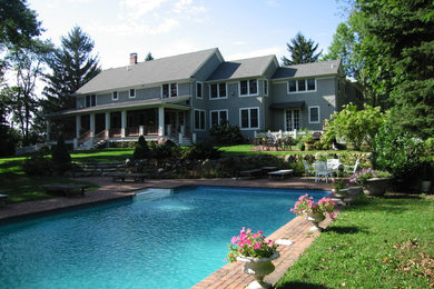 Example of a large classic gray two-story wood exterior home design in New York with a shingle roof