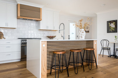 Example of a classic l-shaped kitchen design with an island