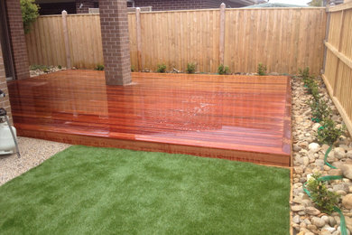 Dock - mid-sized contemporary backyard dock idea in Melbourne with a roof extension
