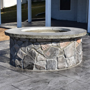 Stamped Concrete with Stone fire pit and stone wall