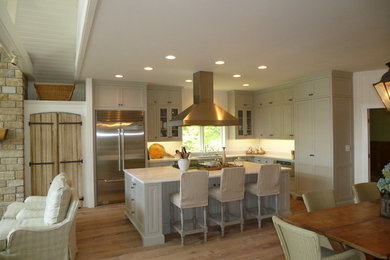 Example of a mid-sized classic l-shaped light wood floor eat-in kitchen design in Other with an undermount sink, marble countertops, stainless steel appliances, shaker cabinets, green cabinets and an island