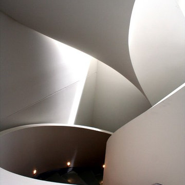 Geometric curved stair with curved dwarf wall balustrade