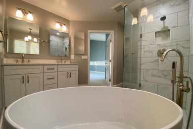 Inspiration for a contemporary master white tile and porcelain tile double-sink, gray floor and mosaic tile floor bathroom remodel in DC Metro with shaker cabinets, white cabinets, quartz countertops, white countertops, a built-in vanity, a hinged shower door, a one-piece toilet and beige walls