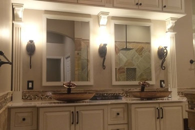 Bathroom - mid-sized transitional master beige tile and porcelain tile porcelain tile and beige floor bathroom idea in Orlando with raised-panel cabinets, white cabinets, white walls, a vessel sink and quartz countertops