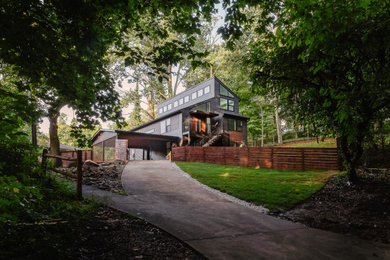 This is an example of a medium sized midcentury two floor detached house in DC Metro with mixed cladding.