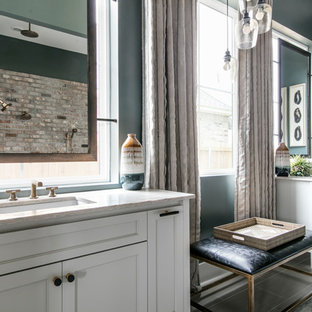 Inspiration for a large transitional master beige tile and stone tile laminate floor and beige floor bathroom remodel in New Orleans with recessed-panel cabinets, white cabinets, an undermount sink, gray walls, quartzite countertops and white countertops