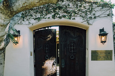 Inspiration for a large mediterranean white adobe gable roof remodel in Santa Barbara