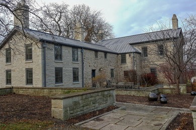 Inspiration for a timeless stone house exterior remodel in Other