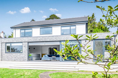 Inspiration for an expansive contemporary two floor rear detached house in Devon with stone cladding.