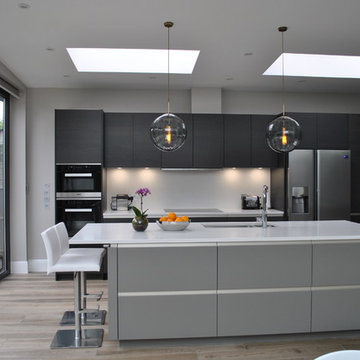 modern handless kitchen in dark wood and matt grey lacquer