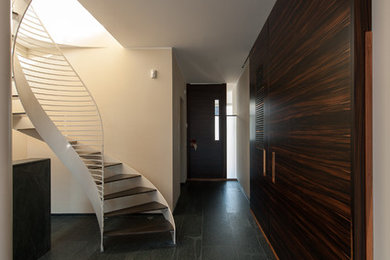 Inspiration for a small contemporary hallway in Other with white walls.