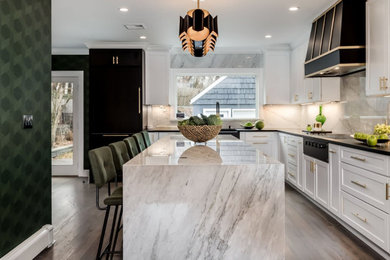 Kitchen - contemporary kitchen idea in New York with granite countertops, white backsplash, an island and black countertops