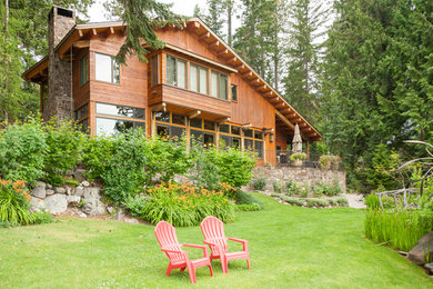 Large rustic brown two-story wood exterior home idea in Seattle