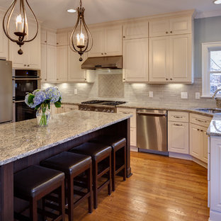 Mid-sized traditional eat-in kitchen remodeling - Mid-sized elegant u-shaped medium tone wood floor and brown floor eat-in kitchen photo in Charlotte with raised-panel cabinets, white cabinets, granite countertops, blue backsplash, ceramic backsplash, stainless steel appliances, an island and a double-bowl sink