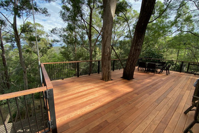 This is an example of an expansive industrial backyard deck in Gold Coast - Tweed.
