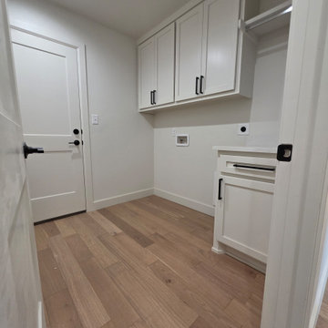 Laundry room with hardwood floors & quartz counter space