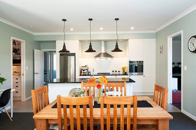 Photo of a transitional dining room in Auckland.