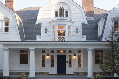 Example of a farmhouse exterior home design in New York