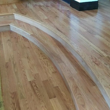 Curved wood stairs into dining room