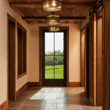 Weathered Antique Paneling and Hand Hewn Timbers in Farmhouse Entry Hallway