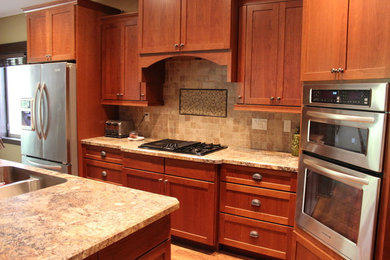 Eat-in kitchen - mid-sized transitional u-shaped dark wood floor and brown floor eat-in kitchen idea in Cedar Rapids with a double-bowl sink, shaker cabinets, dark wood cabinets, granite countertops, beige backsplash, stone tile backsplash, stainless steel appliances and an island