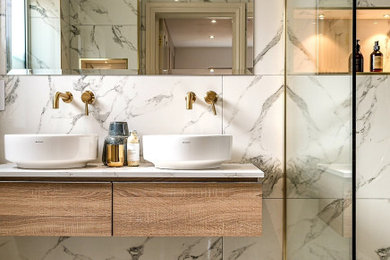 Inspiration for a medium sized contemporary ensuite bathroom in London with flat-panel cabinets, a walk-in shower, a one-piece toilet, porcelain tiles, white walls, porcelain flooring, a console sink, quartz worktops, white floors, an open shower, white worktops, a wall niche, double sinks and a floating vanity unit.