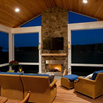 Design Builders screened porch with stone fireplace & Ipe deck in Sykesville MD