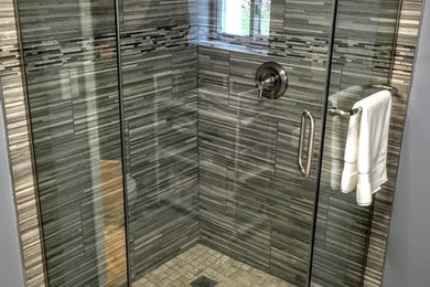 Inspiration for a mid-sized rustic master gray tile and porcelain tile porcelain tile corner shower remodel in Chicago with gray walls and a hinged shower door