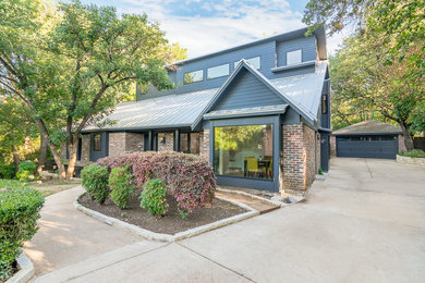 Inspiration for a large modern gray two-story concrete fiberboard exterior home remodel in Austin with a metal roof
