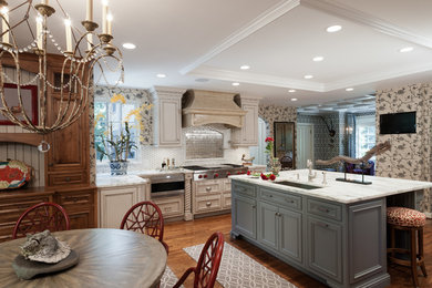 Inspiration for a traditional eat-in kitchen in St Louis with an undermount sink, recessed-panel cabinets, beige cabinets, white splashback, stainless steel appliances, medium hardwood floors and with island.
