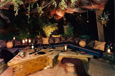 Example of a large trendy backyard patio design in Other with a fire pit