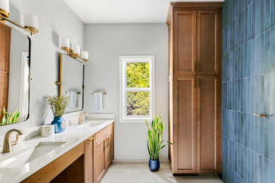 Mid-sized transitional master blue tile and ceramic tile porcelain tile, gray floor and double-sink bathroom photo in Portland with shaker cabinets, medium tone wood cabinets, gray walls, quartz countertops, white countertops and a built-in vanity