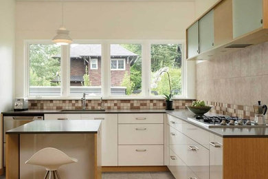 Inspiration for a small transitional l-shaped ceramic tile kitchen remodel in Raleigh with an undermount sink, flat-panel cabinets, white cabinets, quartz countertops, multicolored backsplash, terra-cotta backsplash, stainless steel appliances and an island