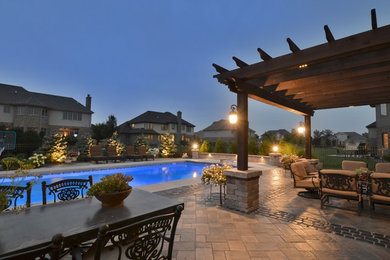 Patio - large eclectic backyard concrete paver patio idea in Chicago with a fire pit and a pergola