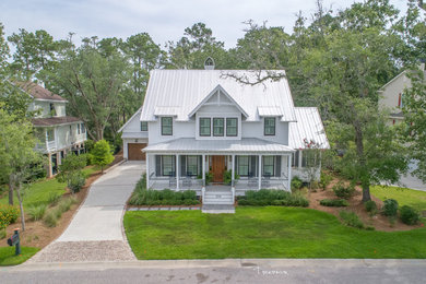 Inspiration for a large craftsman white two-story concrete fiberboard exterior home remodel in Charleston with a metal roof