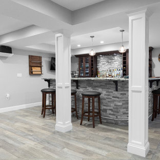 Design ideas for an expansive traditional look-out basement in Boston with grey walls, porcelain flooring, no fireplace and brown floors.