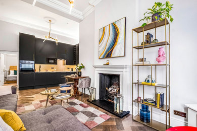Living room - mid-sized contemporary medium tone wood floor living room idea in London with a standard fireplace