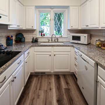 White Kitchen with Granite Countertop and New Flooring