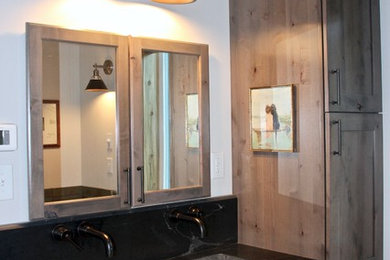 Bathroom - mid-sized rustic master bathroom idea in Other with shaker cabinets, gray cabinets, white walls, an undermount sink, granite countertops and black countertops