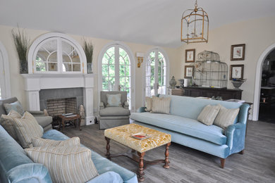 Large elegant formal and enclosed medium tone wood floor and brown floor living room photo in Bridgeport with beige walls, no tv, a standard fireplace and a concrete fireplace