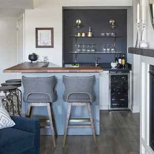 Imagen de sótano clásico renovado con paredes negras, suelo de madera oscura y suelo marrón