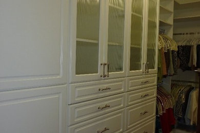 White closet with fluted glass doors