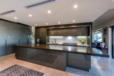 Inspiration for a modern galley kitchen pantry in Perth with an undermount sink, flat-panel cabinets, grey cabinets, quartz benchtops, white splashback, panelled appliances, porcelain floors, with island, multi-coloured floor, black benchtop and stone slab splashback.