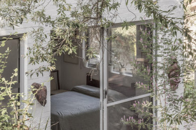 This is an example of a contemporary bedroom in Sydney.
